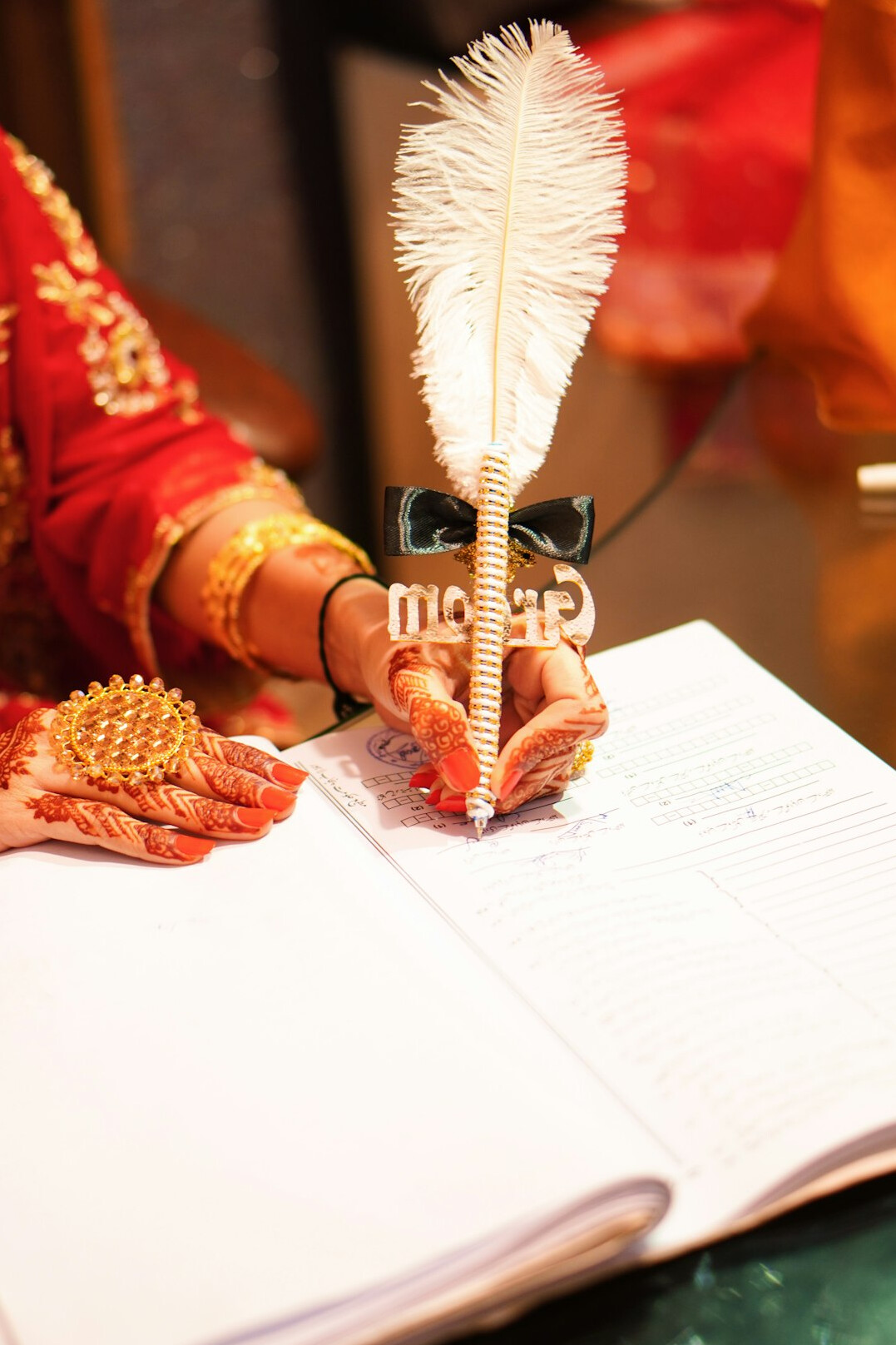 Hand writing in an open notebook with a pen