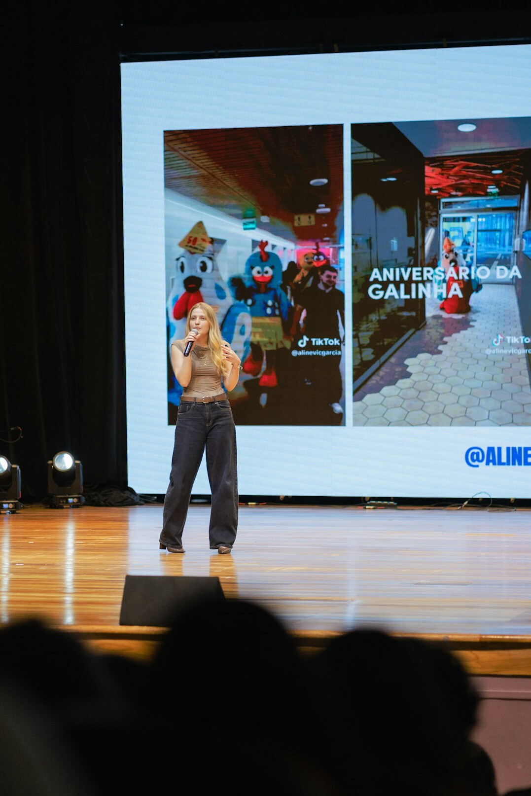 Speaker presenting on stage in front of an audience