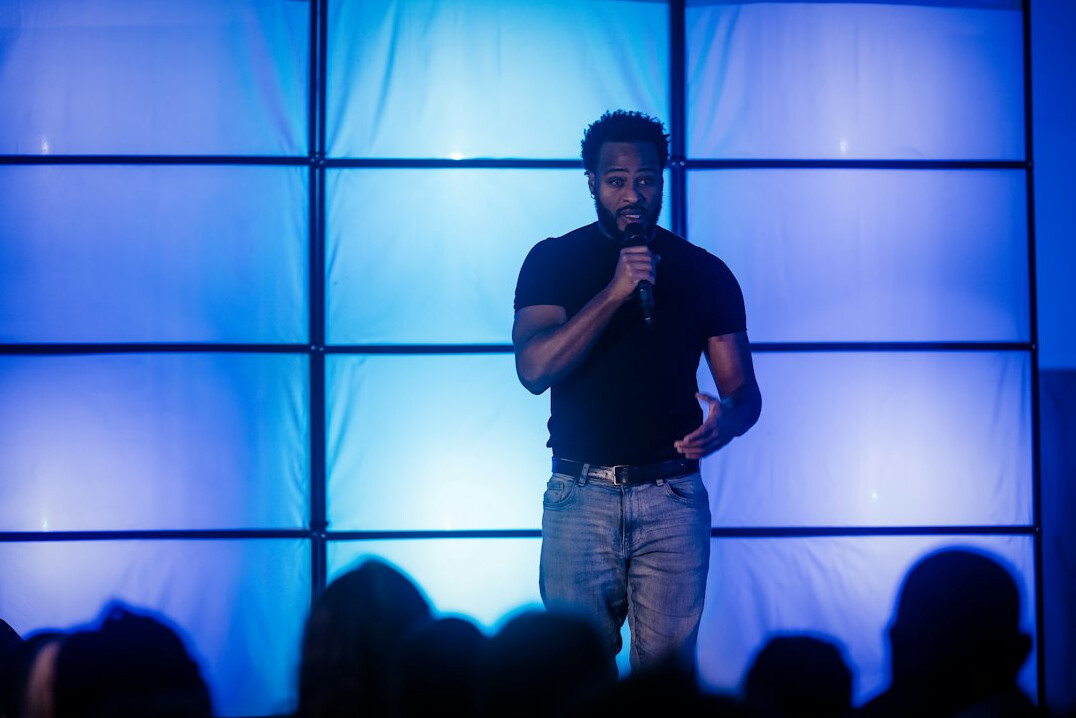 person giving speech on stage