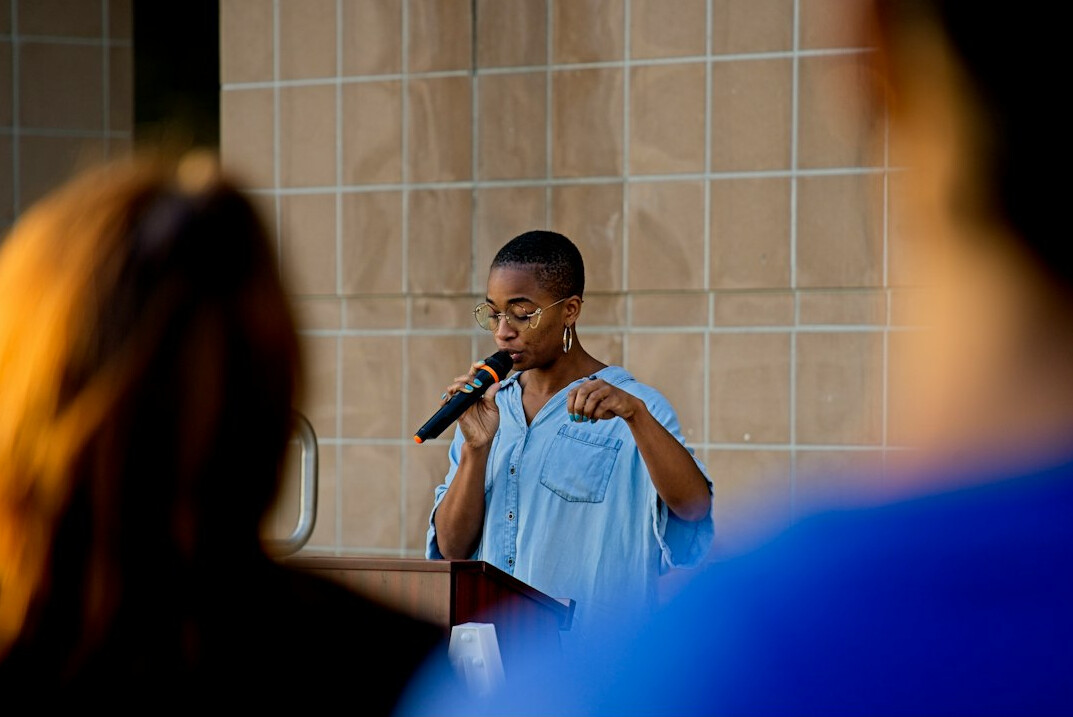 person giving speech on stage
